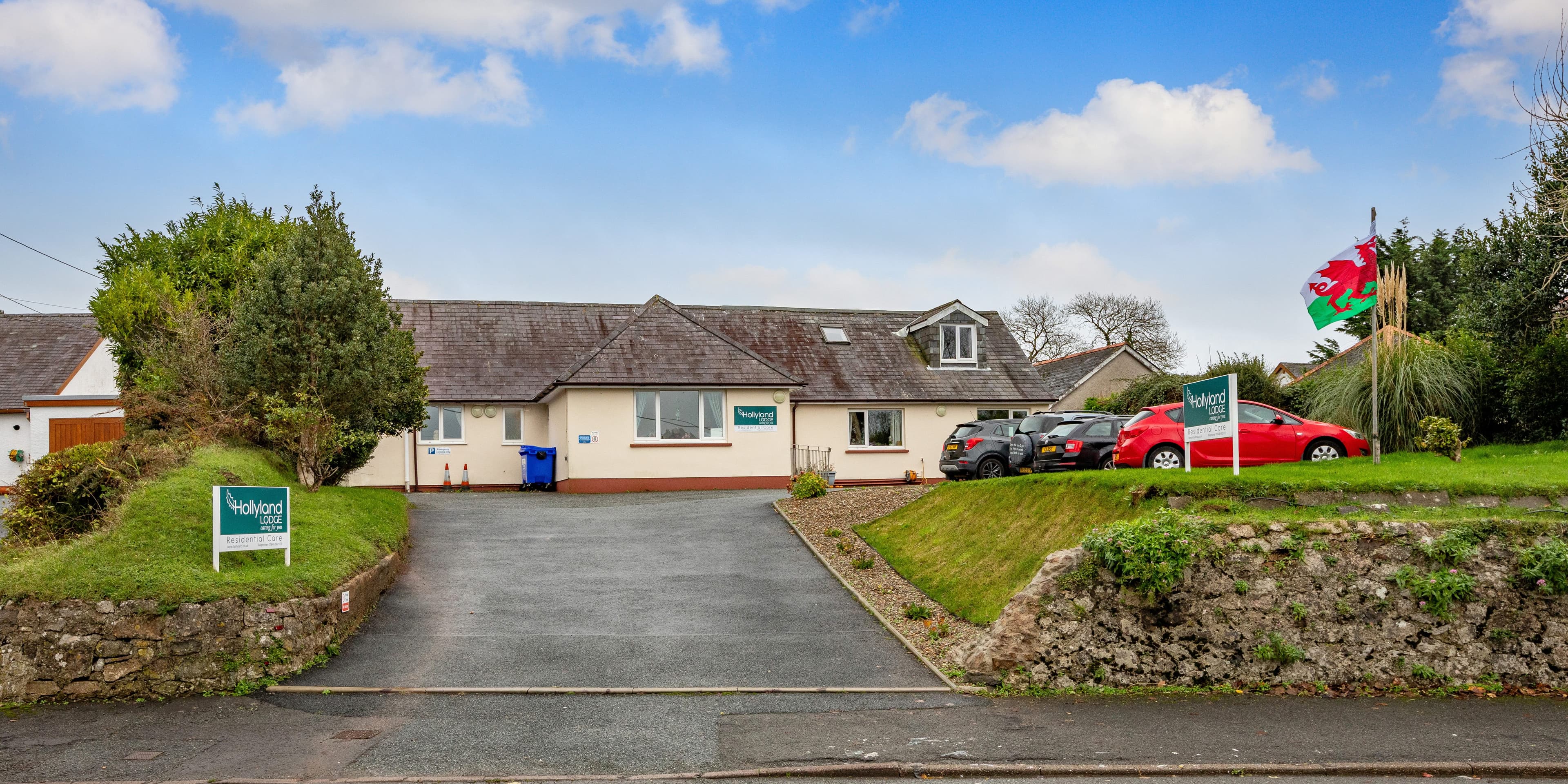 Hollyland Lodge exterior with Welsh flag
